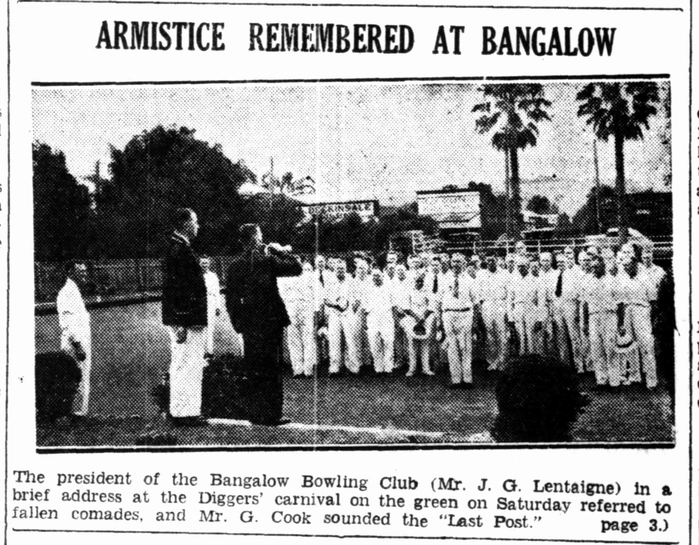 Newspaper photo: bowlers standing on the green during an Armistice address