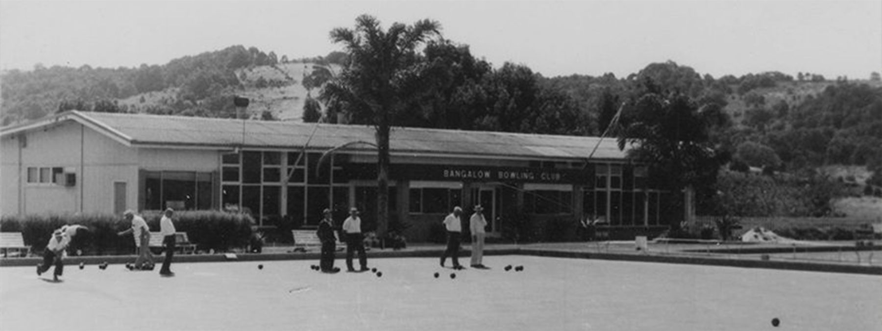Black and white photo: bowlers on the green in front of the new clubhouse on Byron Bay Road